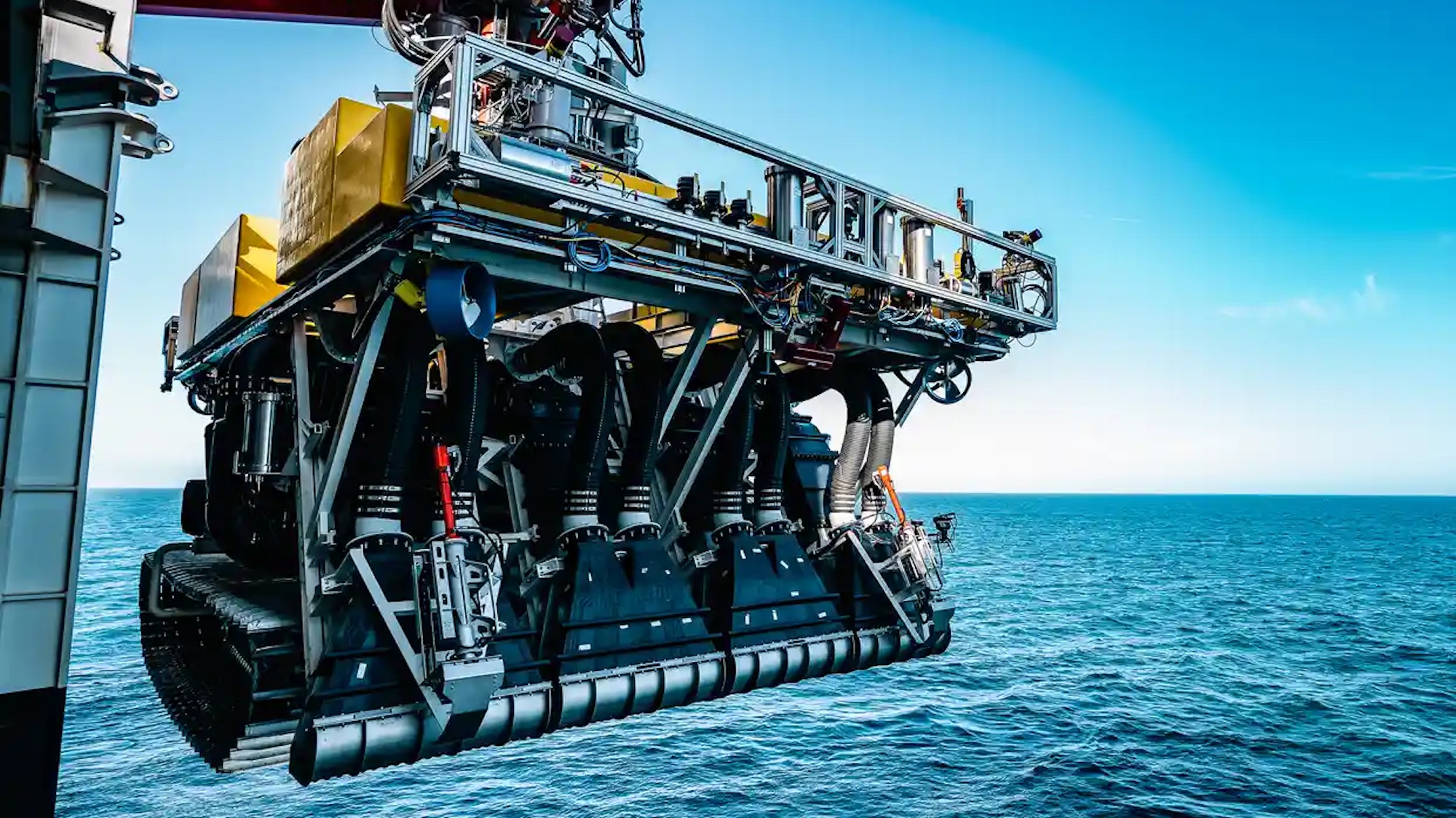 A photo of a machine being lifted to go into the ocean
