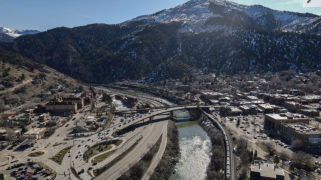 A BNSF Railway train travels east along the Colorado River in Glenwood Springs, Colorado, on its way toward Denver, following the same route proposed for the Uinta Basin Railway project.