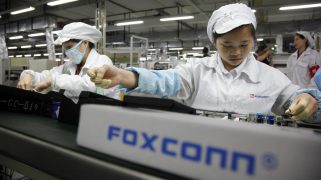 Employees work on the assembly line at Hon Hai Group's Foxconn plant in Shenzhen, China.