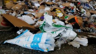 A pile of trash with a plastic Amazon bag front and center.