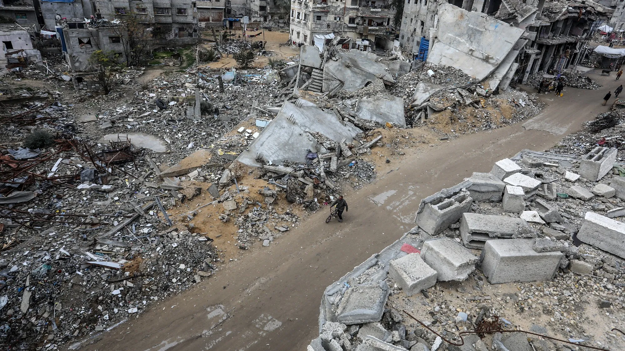 A street is covered in grey debris.