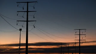 Electric transmission lines next to a sunset