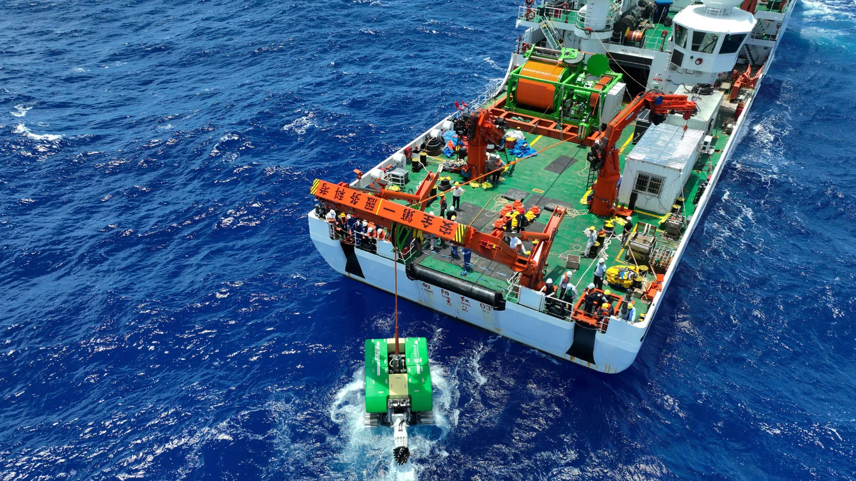 A green ship on the blue sea