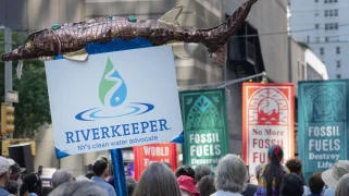 A sign that says "Riverkeeper" with a fake fish on top