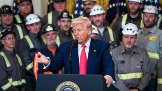 Coal miners listen as President Donald J Trump speaks and signs executive orders about coal production during a "Unleashing American Energy Executive Order Signing Event" in the East Room at the White House