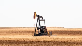An oil rig in a hay field
