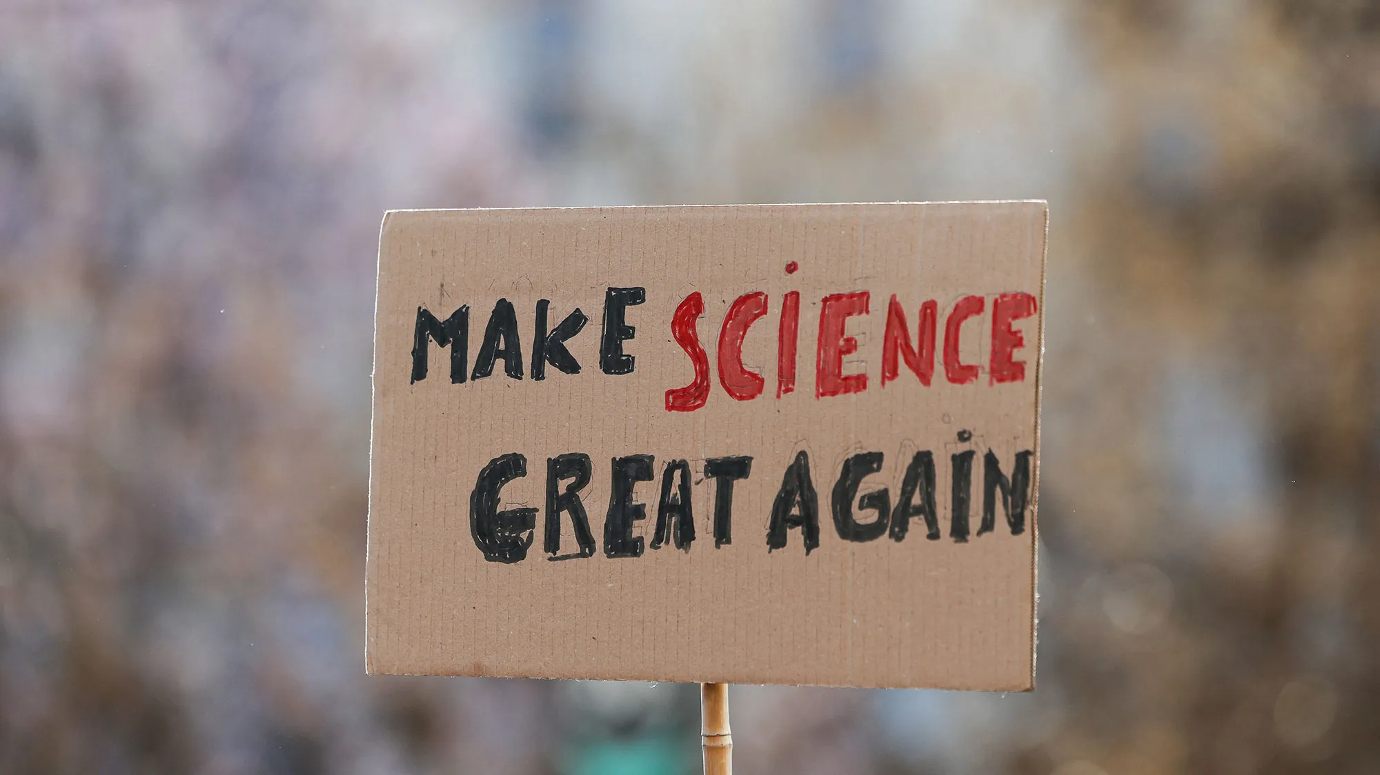 A sign that says "make science great again"