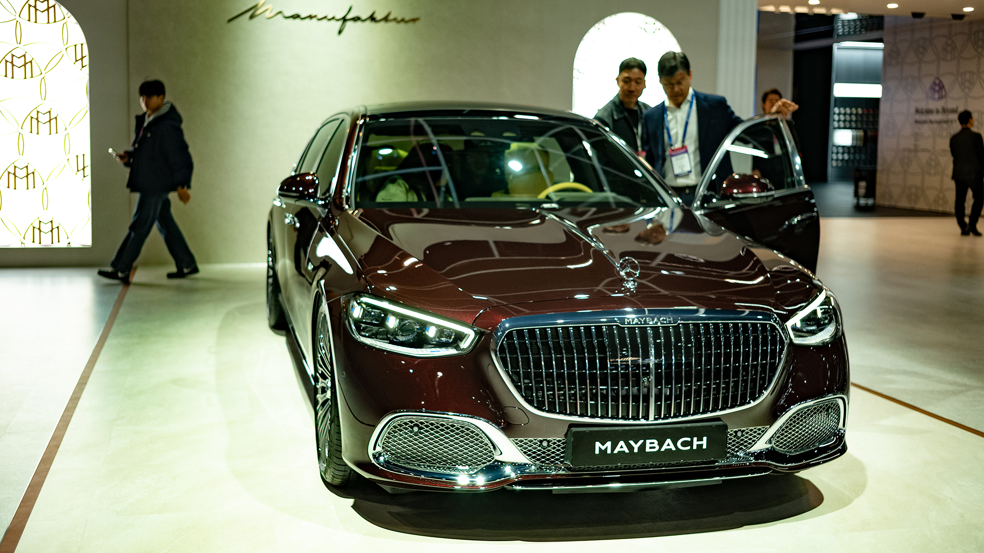 Attendees examine a Mercedes-Maybach luxury sedan on Media Day at the 2025 Seoul Mobility Show at KINTEX in Goyang, South Korea, on April 3, 2025. The event runs for 11 days from April 3 to April 13. (Photo by Chris Jung/NurPhoto via Getty Images)