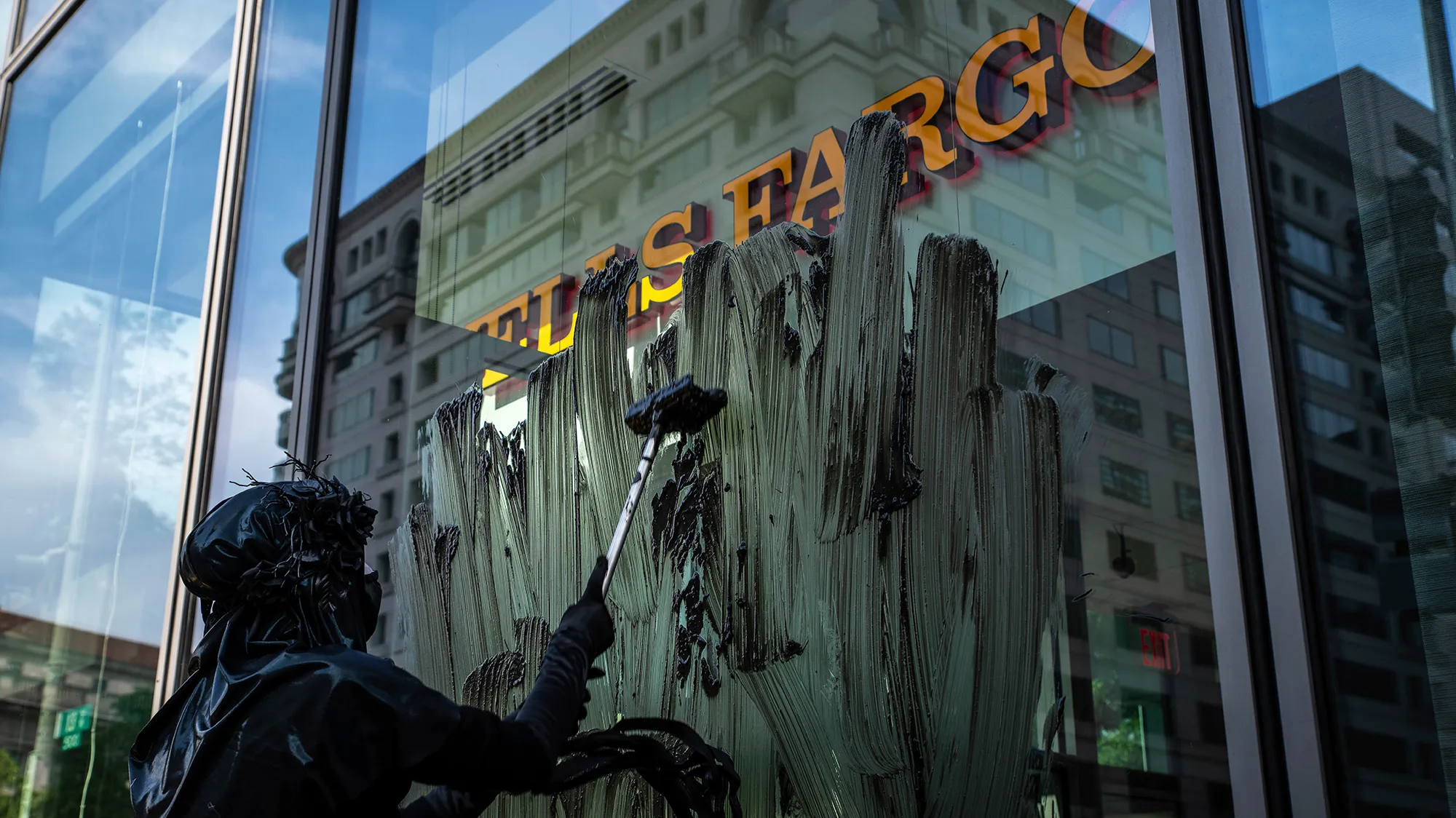 A protester smears oil on wells fargo bank