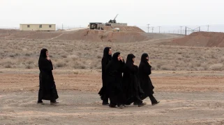 Iranian women walk home from a support rally at the Natanz Uranium Enrichment Facility in 2006. All don full black.