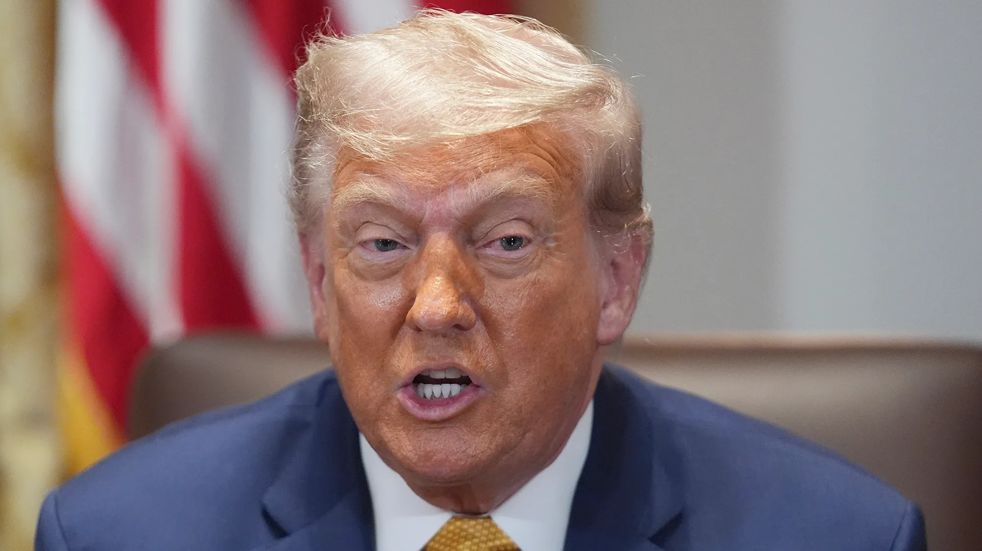 A closeup of Trump's face. His mouth is open.