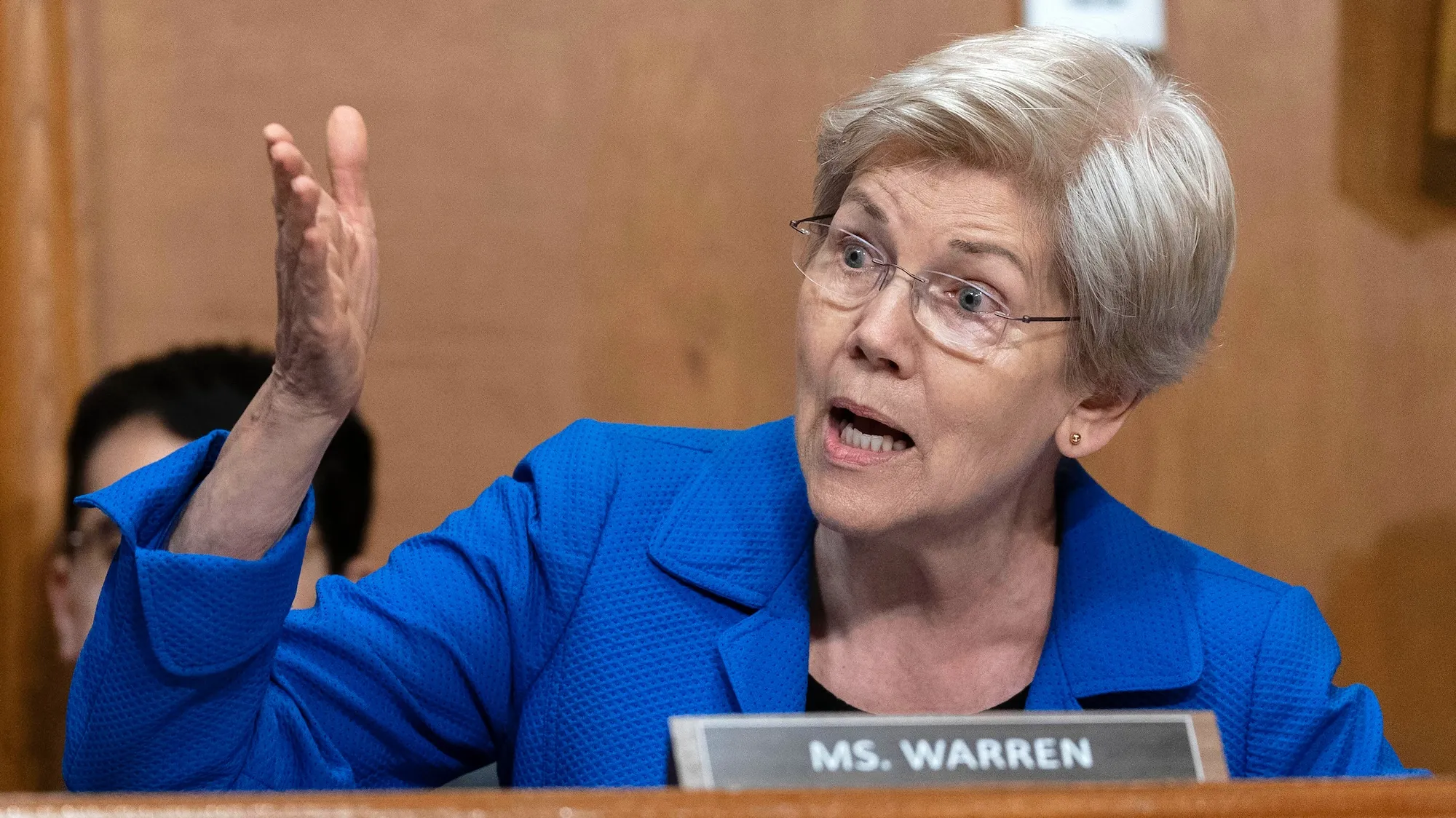 A white woman in a blue jacket