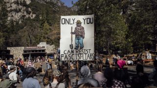 Protesters hold signs during a national day of action against the Trump administration's firing of National Park Service employees at Yosemite National Park, Calif., Saturday, March 1, 2025. (Stephen Lam/San Francisco Chronicle via AP)