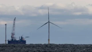 A wind turbine sticking out of the ocean