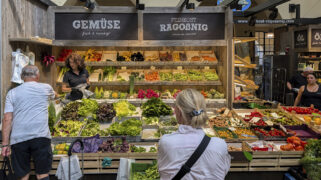 A variety of fresh fruits and vegetables is displayed at a stand inside Stuttgart Market Hall (Markthalle Stuttgart) in Stuttgart, Baden-Wuerttemberg, Germany, on June 20, 2025. Customers shop at the colorful produce display featuring seasonal goods. (Photo by Michael Nguyen/NurPhoto via AP)