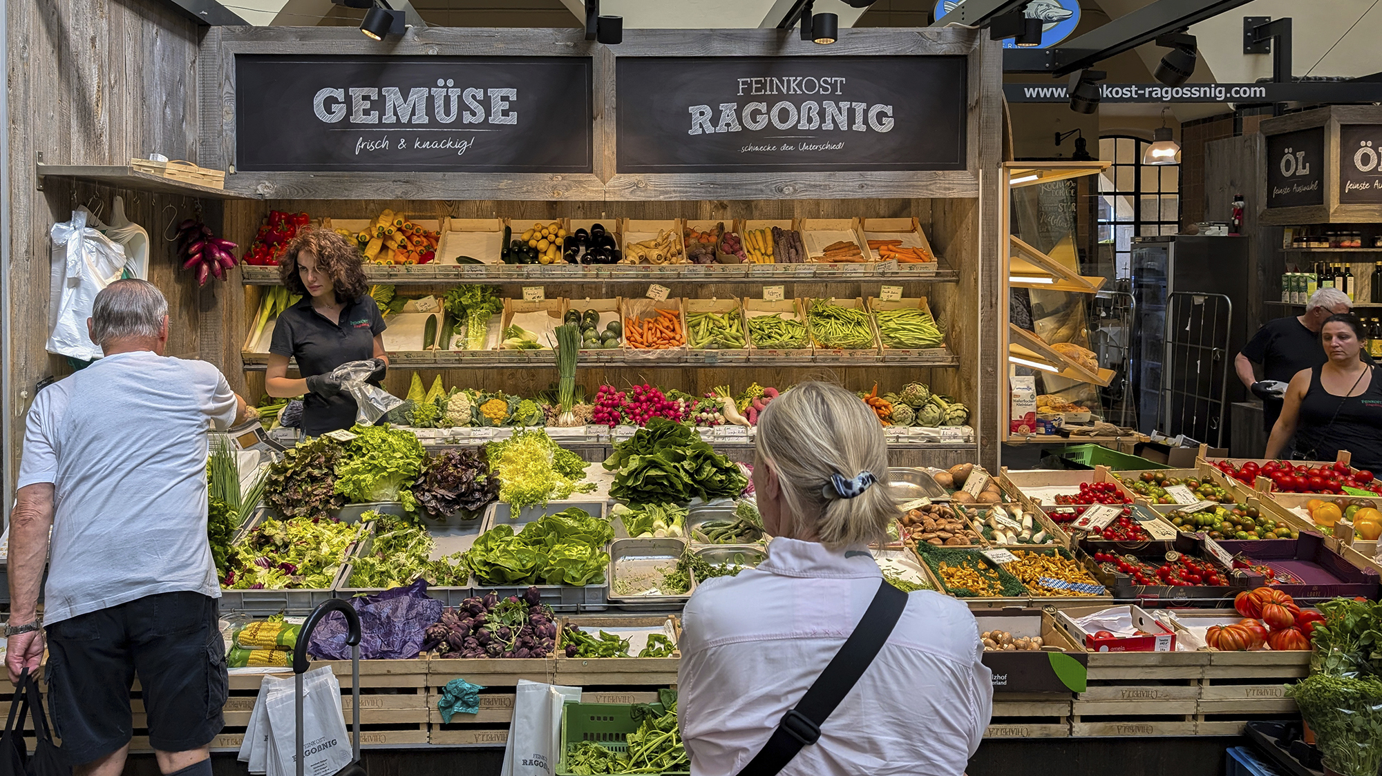A variety of fresh fruits and vegetables is displayed at a stand inside Stuttgart Market Hall (Markthalle Stuttgart) in Stuttgart, Baden-Wuerttemberg, Germany, on June 20, 2025. Customers shop at the colorful produce display featuring seasonal goods. (Photo by Michael Nguyen/NurPhoto via AP)
